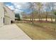 A wide backyard features tall trees, a small fence, and plenty of yard space at 6945 W Mountain Xing, Cumming, GA 30041