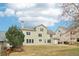 Spacious backyard featuring a well-maintained lawn, mature trees, and a fenced perimeter at 6945 W Mountain Xing, Cumming, GA 30041