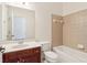 This bathroom offers a stylish vanity and a tiled shower and tub at 6945 W Mountain Xing, Cumming, GA 30041
