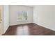 This bedroom features a bright window view and sleek, dark wood floors at 6945 W Mountain Xing, Cumming, GA 30041