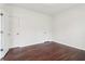 Bedroom with hardwood floors and neutral walls, featuring two doors at 6945 W Mountain Xing, Cumming, GA 30041