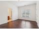 This bedroom offers dark wood floors, light walls, and large window views at 6945 W Mountain Xing, Cumming, GA 30041