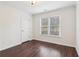 Bright bedroom featuring hardwood floors and ample natural light at 6945 W Mountain Xing, Cumming, GA 30041