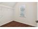Walk-in closet with built-in shelving and hardwood floors at 6945 W Mountain Xing, Cumming, GA 30041