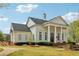 Elegant community clubhouse featuring classic architectural details, lush landscaping, and paved driveway at 6945 W Mountain Xing, Cumming, GA 30041