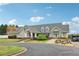 Community clubhouse featuring a well-manicured lawn, covered entrance, and ample parking at 6945 W Mountain Xing, Cumming, GA 30041