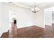 Bright dining room area featuring paneled walls, hardwood flooring, and an open concept design at 6945 W Mountain Xing, Cumming, GA 30041