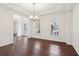 Elegant dining room featuring paneled walls, hardwood flooring, and an entry foyer view at 6945 W Mountain Xing, Cumming, GA 30041