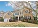 Charming two-story brick home with a welcoming front porch and meticulously landscaped front yard at 6945 W Mountain Xing, Cumming, GA 30041