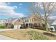 Beautiful brick home boasts a manicured lawn, mature landscaping, and a spacious two-car garage at 6945 W Mountain Xing, Cumming, GA 30041
