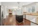 Modern kitchen with an island, stainless appliances, white cabinets, granite counters, and hardwood floors at 6945 W Mountain Xing, Cumming, GA 30041