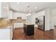 Bright kitchen with white cabinets, stainless steel appliances, granite counters, and hardwood floors at 6945 W Mountain Xing, Cumming, GA 30041