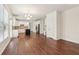Open concept kitchen with white cabinets, granite counters, stainless appliances, and hardwood floors at 6945 W Mountain Xing, Cumming, GA 30041