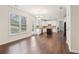 Bright kitchen with white cabinetry, stainless steel appliances, island, and hardwood floors at 6945 W Mountain Xing, Cumming, GA 30041