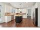 Kitchen with stainless appliances, white cabinets, an island, granite countertops and hardwood floors at 6945 W Mountain Xing, Cumming, GA 30041
