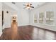 Open-concept living area with hardwood floors and lots of natural light at 6945 W Mountain Xing, Cumming, GA 30041