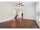 Inviting living room boasts hardwood floors, bright white walls, and an open layout to the staircase at 6945 W Mountain Xing, Cumming, GA 30041