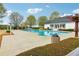Community pool featuring a sun deck, white clubhouse, and surrounding trees and landscaping at 6945 W Mountain Xing, Cumming, GA 30041