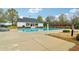 Community pool featuring a sun deck, a white clubhouse, and trees at 6945 W Mountain Xing, Cumming, GA 30041