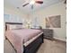 Bedroom with a ceiling fan, a bed with a patterned comforter, and natural light from the windows at , Acworth, GA 30101