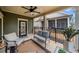 Cozy covered patio with comfortable seating, ceiling fan, and door to the home at , Acworth, GA 30101