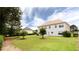 Expansive backyard with well-kept lawn, mature trees, and a glimpse of neighboring houses at 1236 Saxony Se Dr, Conyers, GA 30013