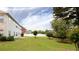 Well-maintained backyard with lush lawn, trees, and a white fence, offering privacy and space at 1236 Saxony Se Dr, Conyers, GA 30013