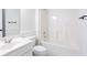 All-white bathroom featuring a tub/shower combo and a vanity with a sink and mirror at 1236 Saxony Se Dr, Conyers, GA 30013
