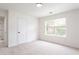 Bedroom featuring a window and door leading to hallway at 1236 Saxony Se Dr, Conyers, GA 30013
