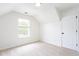 A bright bedroom with large window, plush carpet, and white door for a modern look at 1236 Saxony Se Dr, Conyers, GA 30013