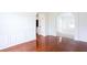 Elegant dining room with wainscoting, hardwood flooring, and view to the hallway at 1236 Saxony Se Dr, Conyers, GA 30013