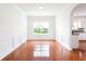 Elegant dining room with hardwood floors, wainscoting, and a window with views to the outside at 1236 Saxony Se Dr, Conyers, GA 30013