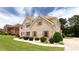 Beautiful brick home with manicured front yard and walkway lined with white rocks at 1236 Saxony Se Dr, Conyers, GA 30013