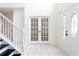 Inviting foyer with tile floors, staircase, and elegant French doors to additional rooms at 1236 Saxony Se Dr, Conyers, GA 30013