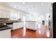 Open kitchen with white cabinets, stainless steel appliances, black countertops, and a central island at 1236 Saxony Se Dr, Conyers, GA 30013