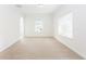 Spacious living room with neutral carpet, bright windows, and view to the hallway with arched doorway at 1236 Saxony Se Dr, Conyers, GA 30013