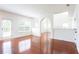 Bright living room with hardwood floors, neutral paint, and large windows at 1236 Saxony Se Dr, Conyers, GA 30013