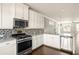 Contemporary kitchen featuring stainless steel appliances, granite countertops, and modern cabinetry at 3032 Hartford Mill Pl, Duluth, GA 30097