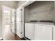 Laundry room with washer, dryer, and wire rack at 3032 Hartford Mill Pl, Duluth, GA 30097