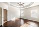 Spacious main bedroom with hardwood floors, tray ceiling, and natural light at 3032 Hartford Mill Pl, Duluth, GA 30097