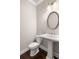 Powder room with pedestal sink and hardwood floors at 3032 Hartford Mill Pl, Duluth, GA 30097