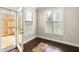 Bright room with hardwood floors and access to an outdoor deck at 3032 Hartford Mill Pl, Duluth, GA 30097