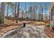 Backyard featuring a concrete patio and surrounded by trees and a wooden fence at 3080 Autumn Woods Ct, Douglasville, GA 30135