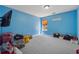 Bedroom featuring blue walls, carpet flooring and a window at 3080 Autumn Woods Ct, Douglasville, GA 30135