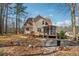 View of the backyard featuring an upper deck and a screened-in sunroom at 3080 Autumn Woods Ct, Douglasville, GA 30135