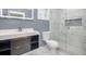Contemporary bathroom featuring marble tile, a modern vanity, and a glass-enclosed shower with built-in niche at 441 Pomona Sw Cir, Atlanta, GA 30315