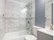 Modern bathroom featuring marble tile, glass shower door and stylish vanity at 441 Pomona Sw Cir, Atlanta, GA 30315