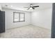 Spacious bedroom with a ceiling fan, a large window, and neutral-toned carpet flooring for a comfortable atmosphere at 441 Pomona Sw Cir, Atlanta, GA 30315