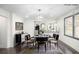 Staged dining room with stylish furniture, chandelier and art work opening up to a view of the kitchen at 441 Pomona Sw Cir, Atlanta, GA 30315
