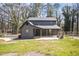 Backyard view of home shows modern grey siding, new roof and a newly poured concrete driveway at 441 Pomona Sw Cir, Atlanta, GA 30315